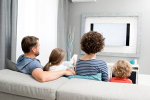 Family Watching TV in Living Room